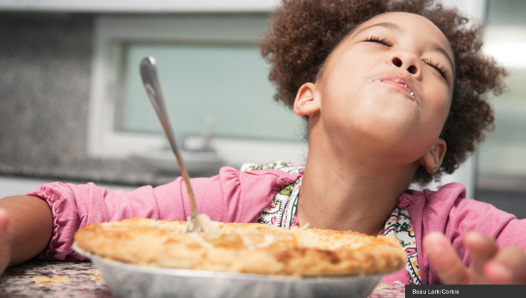 child eating pie