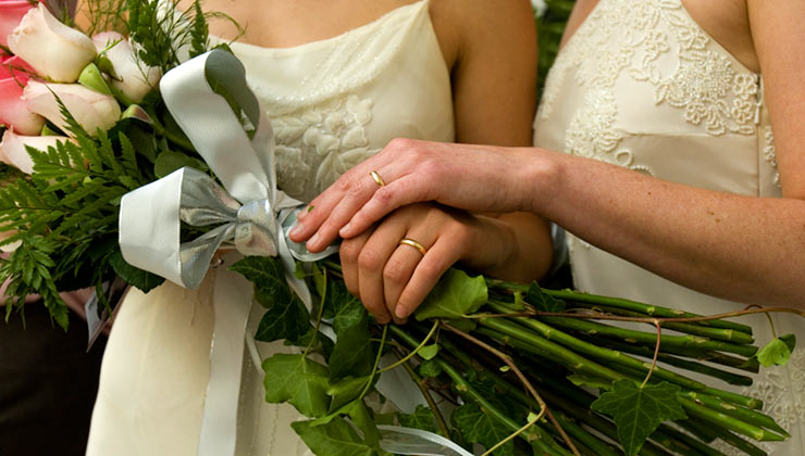 Two women hold hands after getting married at city hall in San Francisco, California.