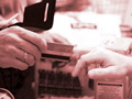 man handing his credit card