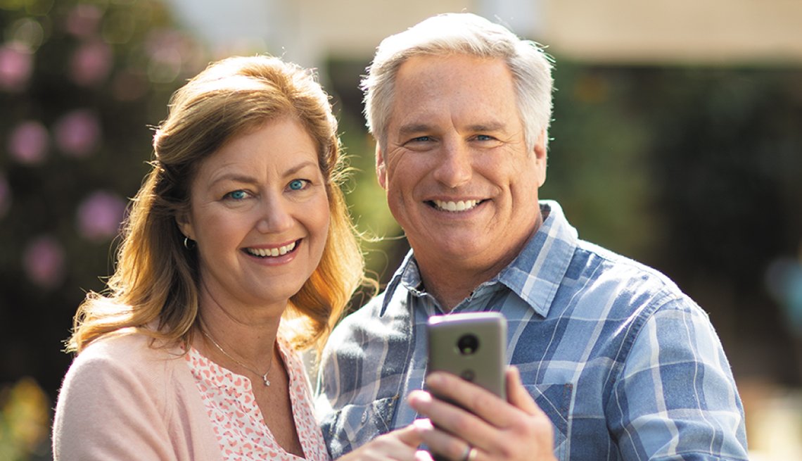 Smiling Couple Looking at Phone