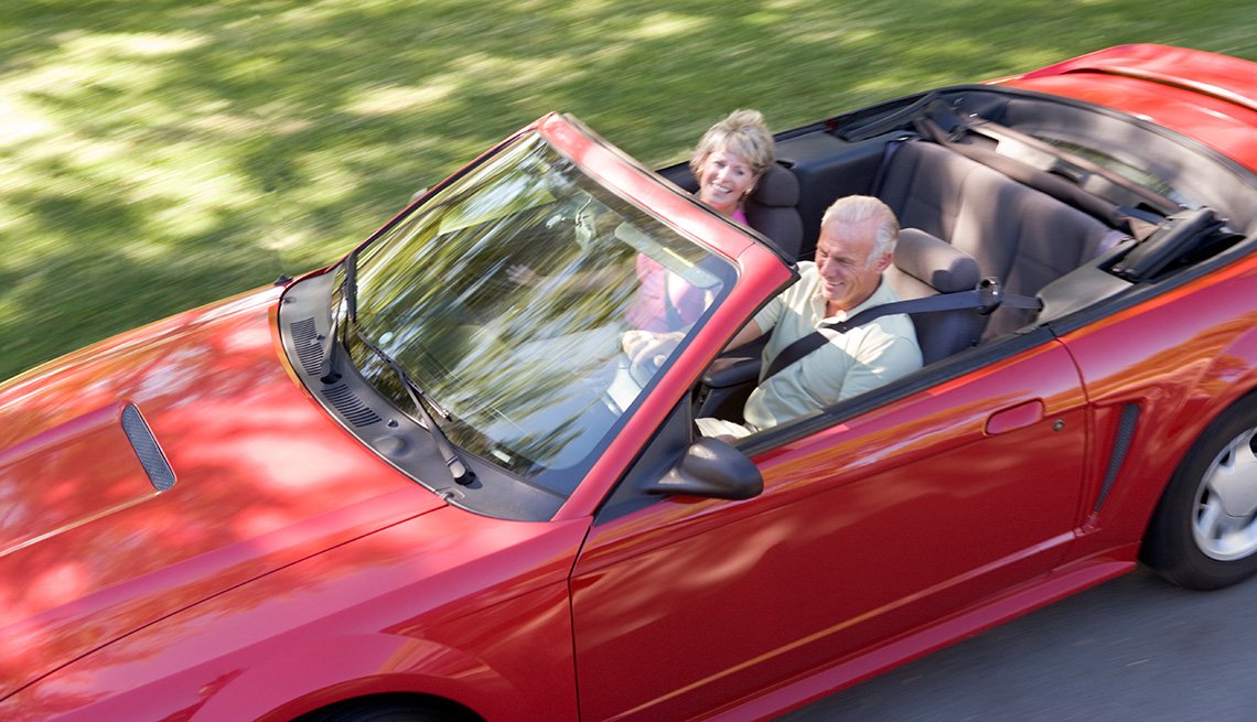 Couple in convertible car smiling, Auto Insurance
