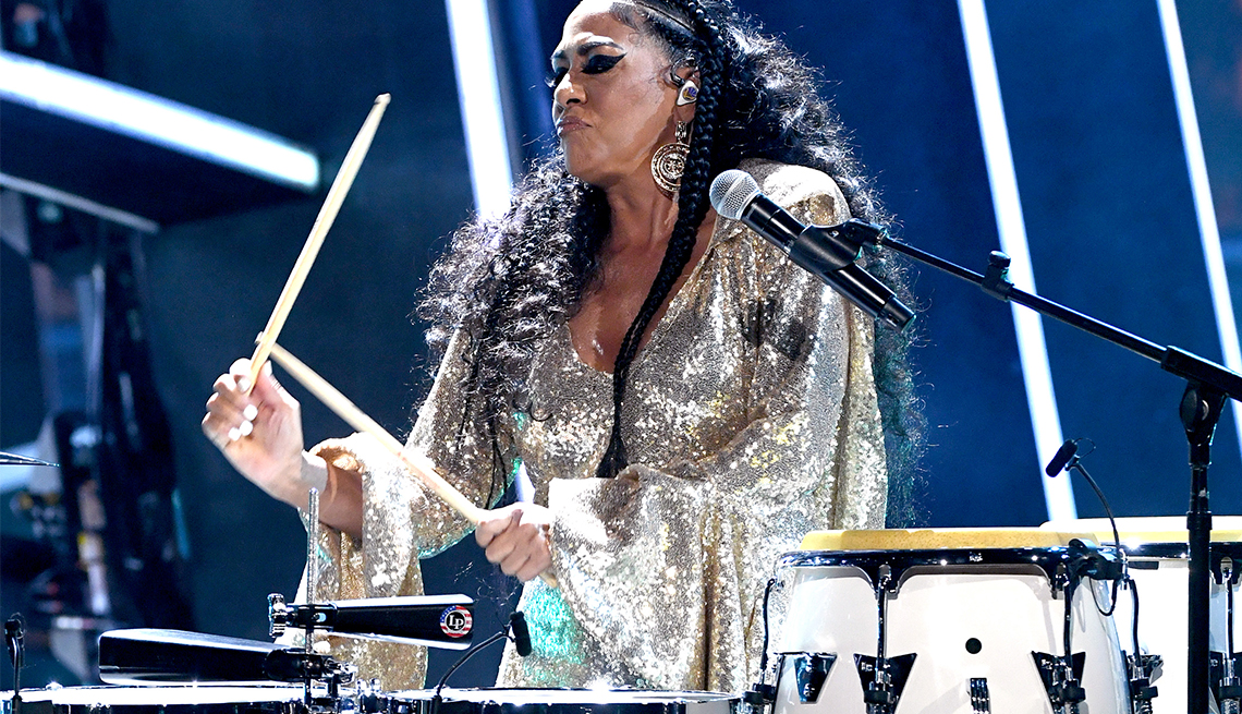 sheila e playing drums and wearing sparkly silver outfit sheila e playing drums and wearing sparkly silver outfit
