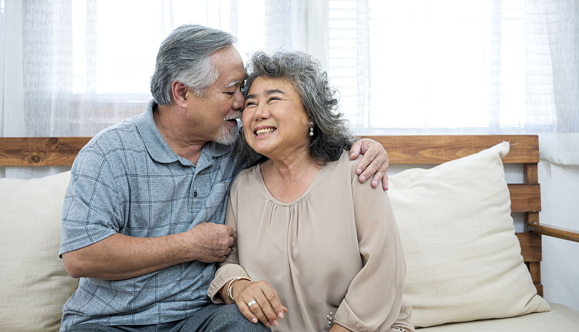  couple kissing and cuddling on couch in nursing home