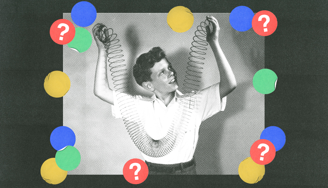 black and white image of a boy holding both ends of slinky, surrounded by blue, red, green and yellow circles with question marks in them; black background black and white image of a boy holding both ends of slinky, surrounded by blue, red, green and yellow circles with question marks in them; black background