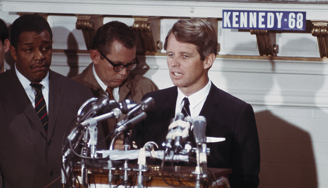 Robert Kennedy standing at a podium.