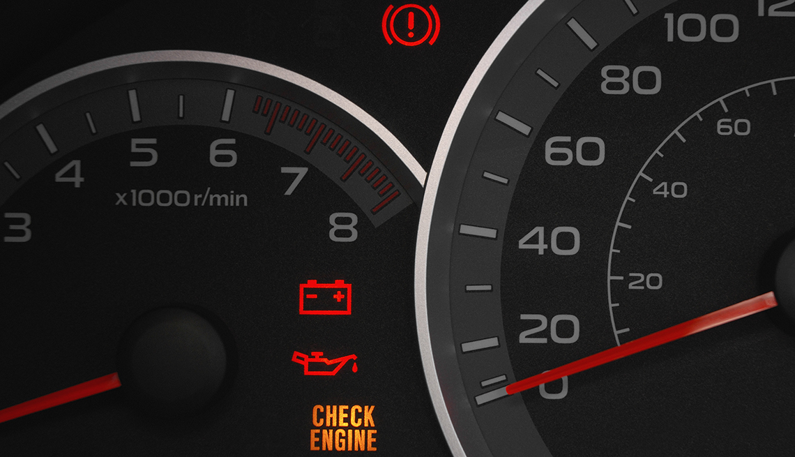 close up of dials and warning lights on a car dashboard