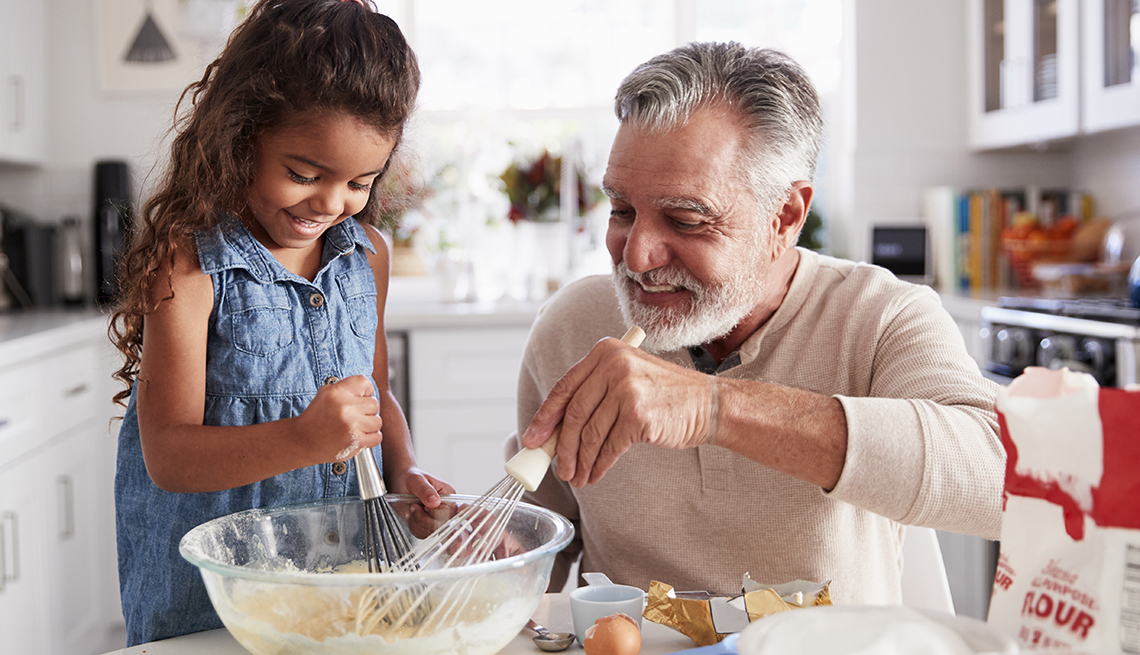 Young girl and her grandad baking