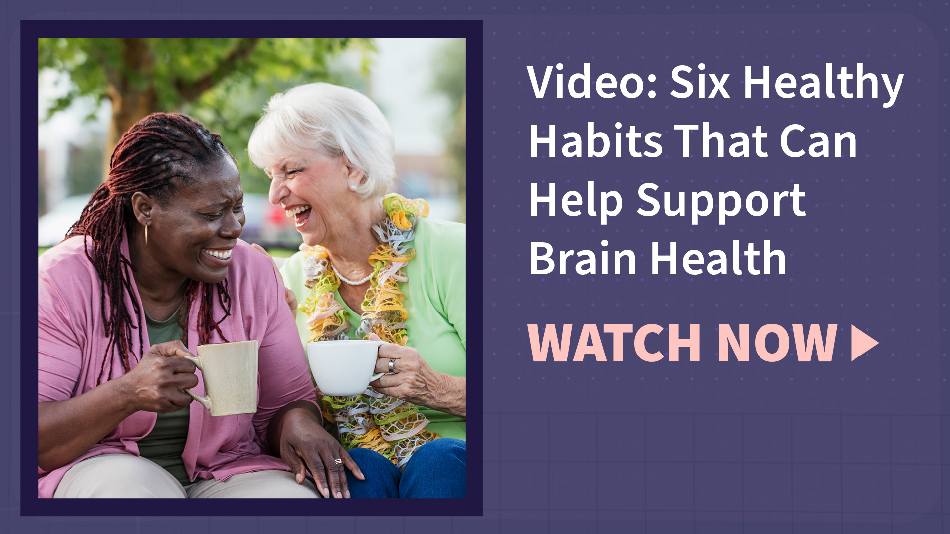Two women laughing and drinking coffee together