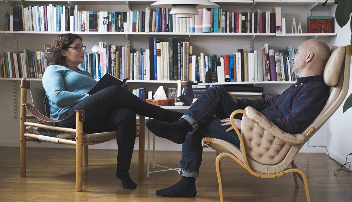 female therapist talking to a male patient in her office