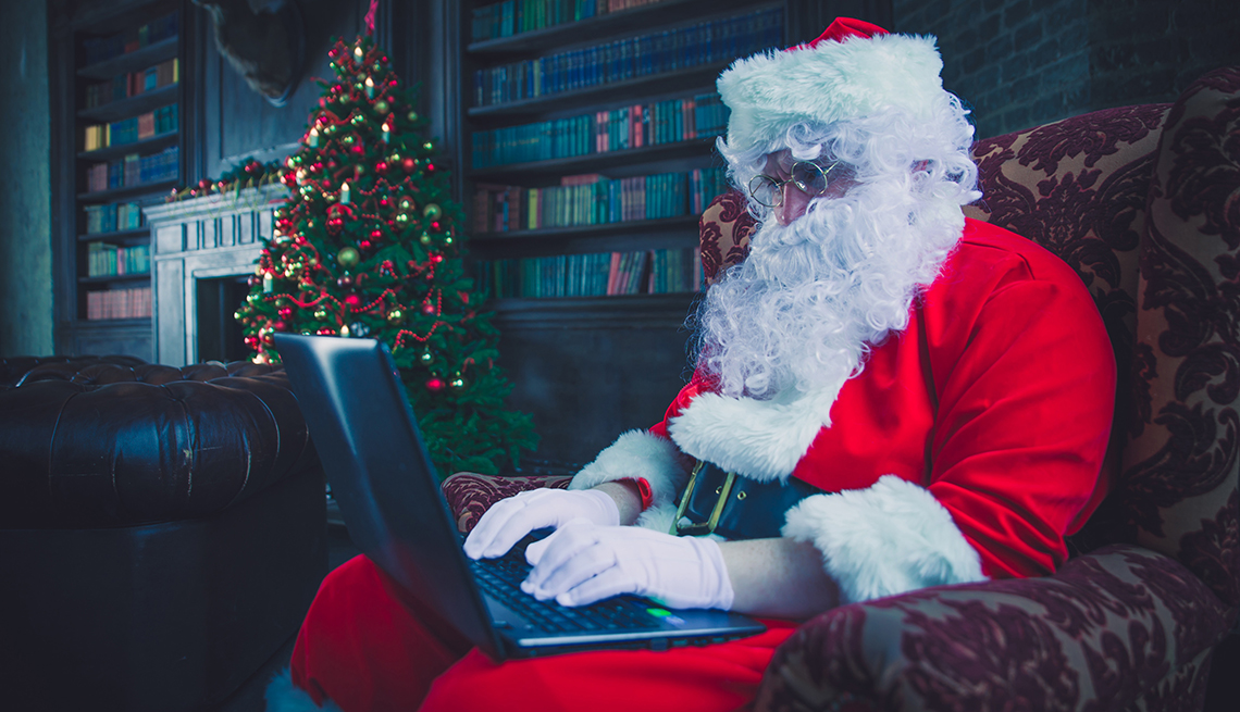 Person in Santa costume on a computer Person in Santa costume on a computer