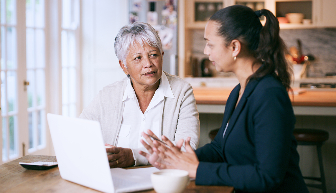 two women talking at a table