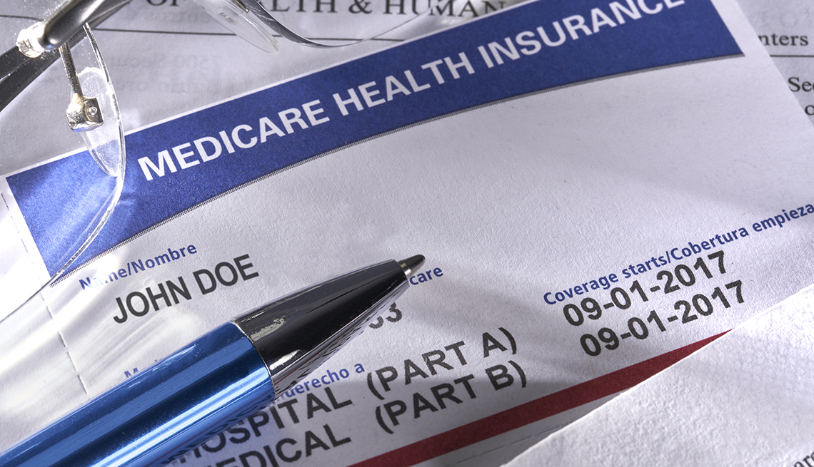 Tarjeta de Medicare, anteojos y bolígrafo en un escritorio